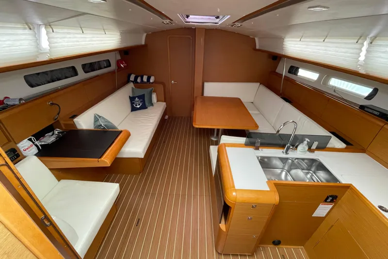 Eclipse Yacht Photos Pics Interior of 2014 Jeanneau Sun Odyssey 439 sailboat with modern seating and kitchen area.