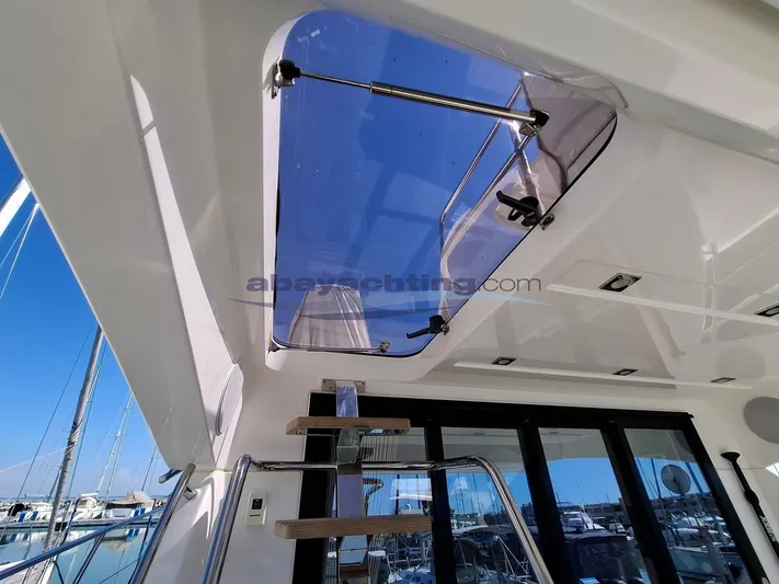  Yacht Photos Pics 2019 Prestige 420 Flybridge yacht interior with skylight and ladder, docked at marina.