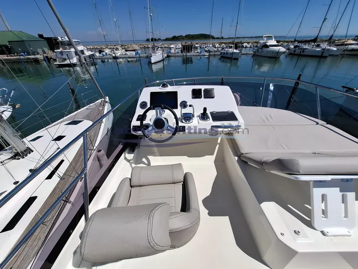  Yacht Photos Pics Flybridge of 2019 Prestige 420 yacht docked in marina, featuring helm and seating area.