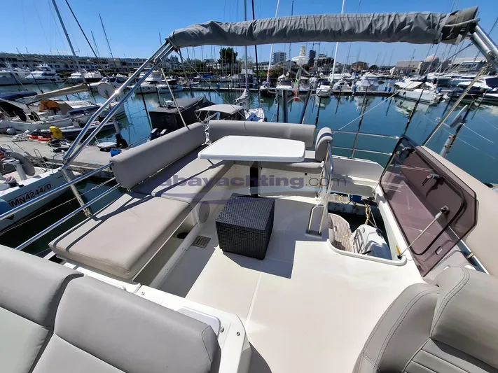  Yacht Photos Pics Flybridge of 2019 Prestige 420 yacht in marina, featuring seating and table.