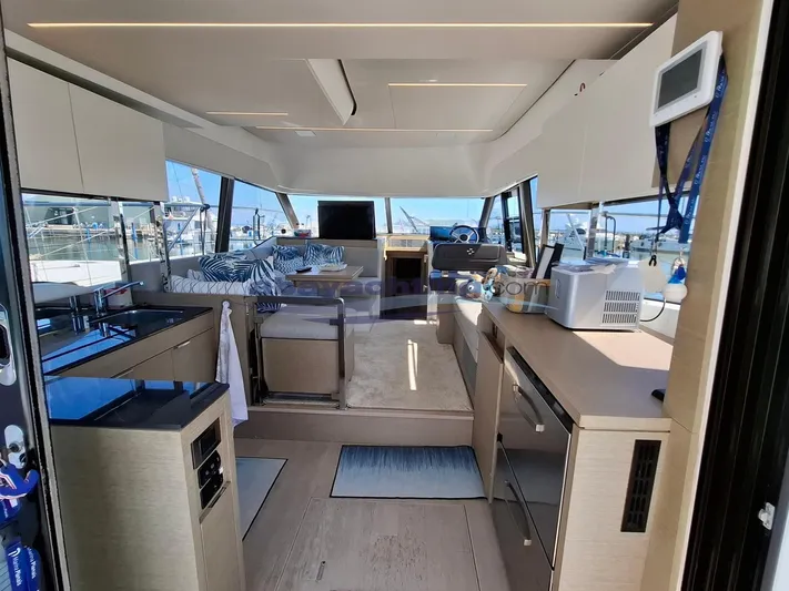  Yacht Photos Pics Interior of 2019 Prestige 420 Flybridge yacht, featuring modern kitchen and spacious seating area.