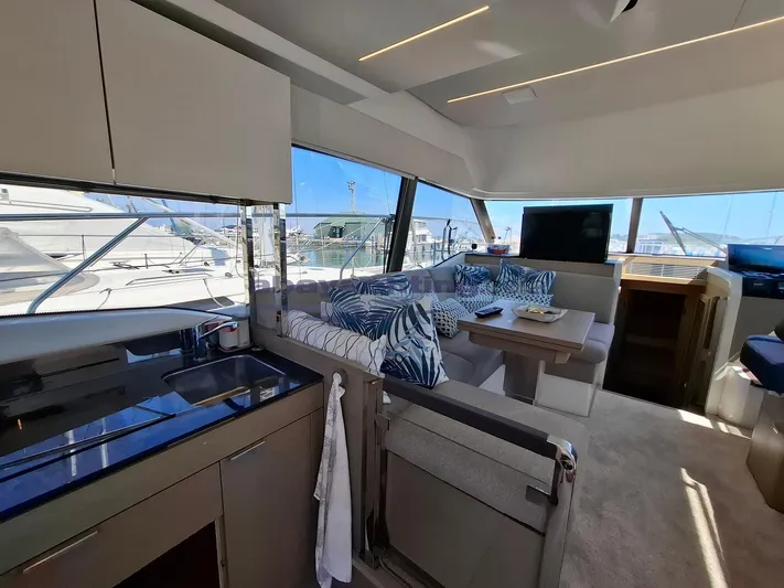  Yacht Photos Pics Luxurious interior of 2019 Prestige 420 Flybridge yacht with modern kitchen and seating area.