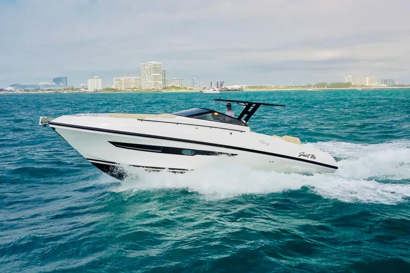  Yacht Photos Pics 2023 Rio Yachts Daytona 34 cruising on ocean near city skyline.