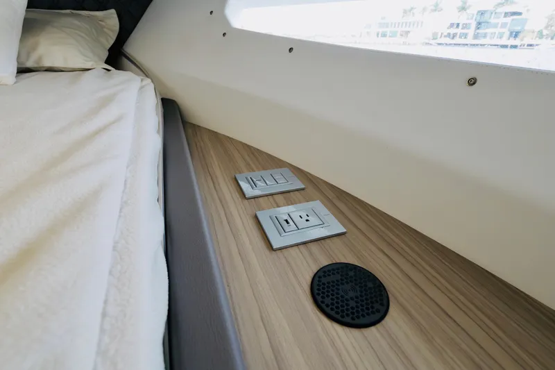  Yacht Photos Pics 2023 Rio Yachts Daytona 34 interior with outlets and speaker on wood panel.
