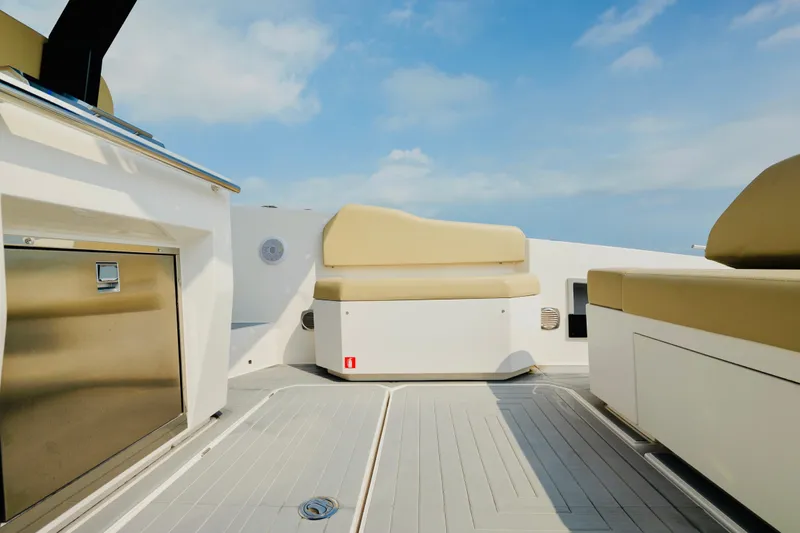  Yacht Photos Pics 2023 Rio Yachts Daytona 34 interior with beige seating and stainless steel accents under a clear sky.