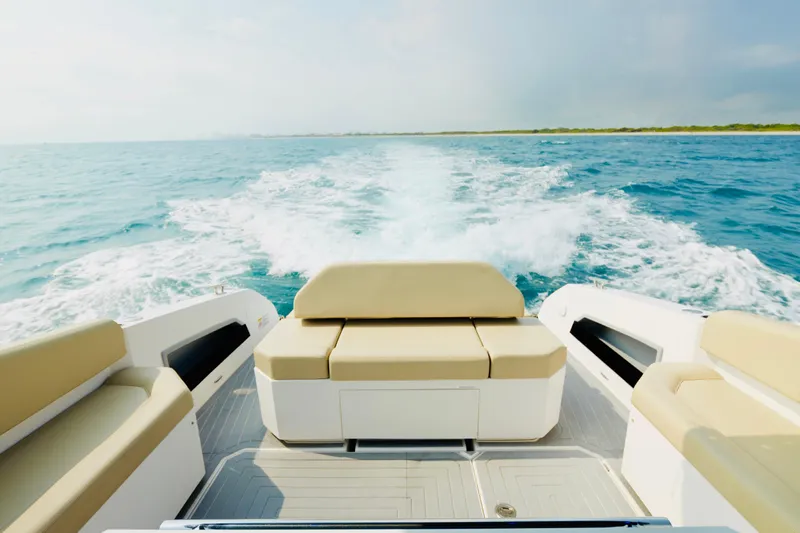  Yacht Photos Pics 2023 Rio Yachts Daytona 34 cruising on open water, showcasing luxurious seating and wake trail.