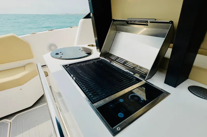  Yacht Photos Pics Outdoor grill on 2023 Rio Yachts Daytona 34, with ocean view and seating area.