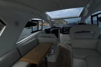 Interior of 2024 Bavaria Sport 36 Open yacht with sleek seating and wooden table.