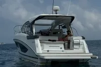 2024 Bavaria Sport 36 Open yacht on calm sea with inflatable nearby.