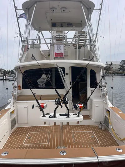 Rainmaker Yacht Photos Pics 2004 Ocean Yachts 40 SS fishing boat with rods, docked at marina.