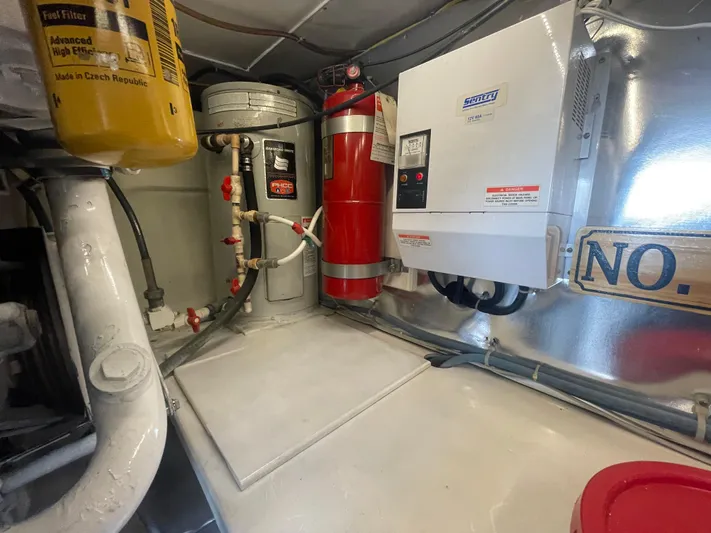 Rainmaker Yacht Photos Pics Engine room of 2004 Ocean Yachts 40 SS with fire extinguisher and equipment.