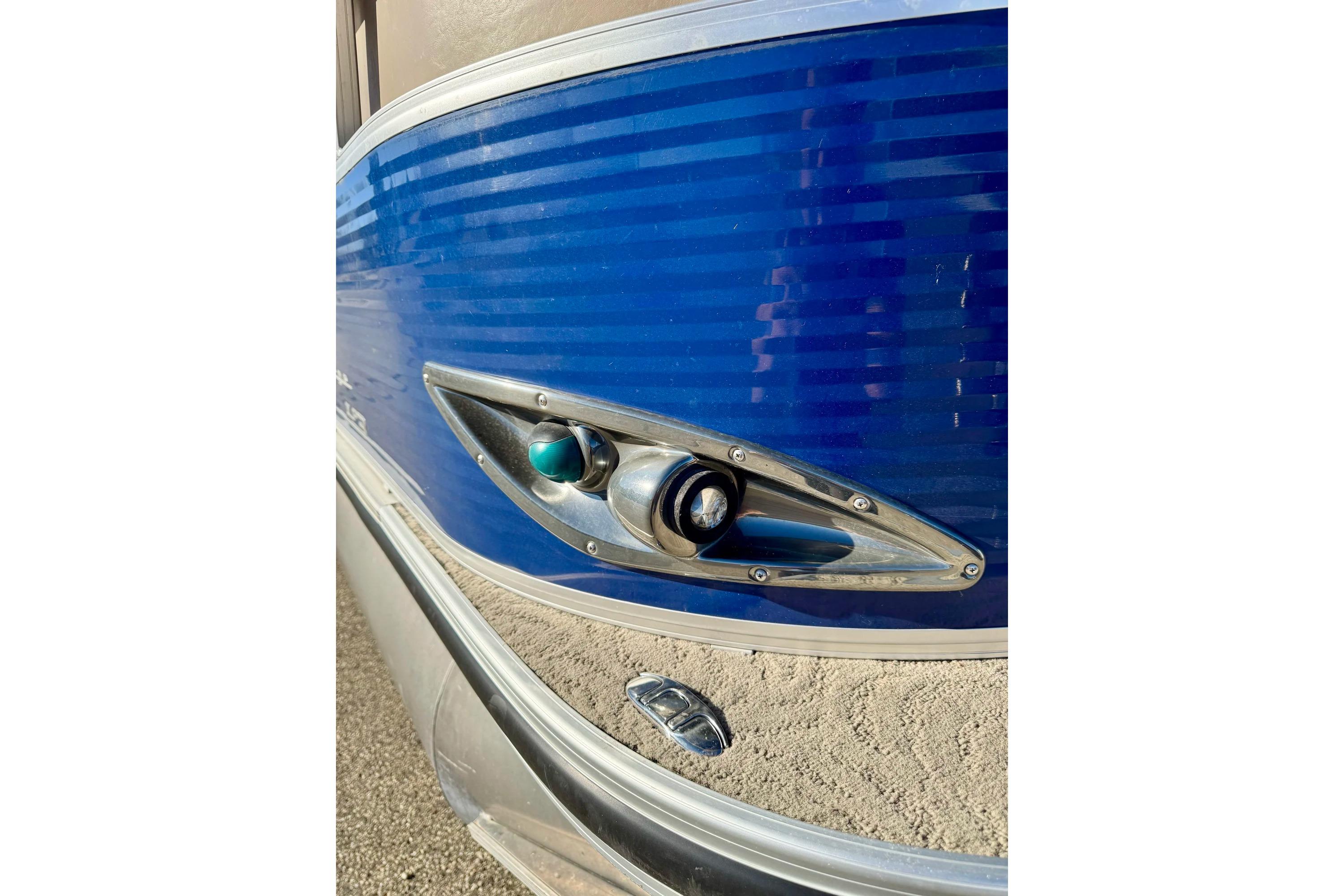 2012 Regency Sun Tracker Party Barge, blue exterior detail with chrome accents.