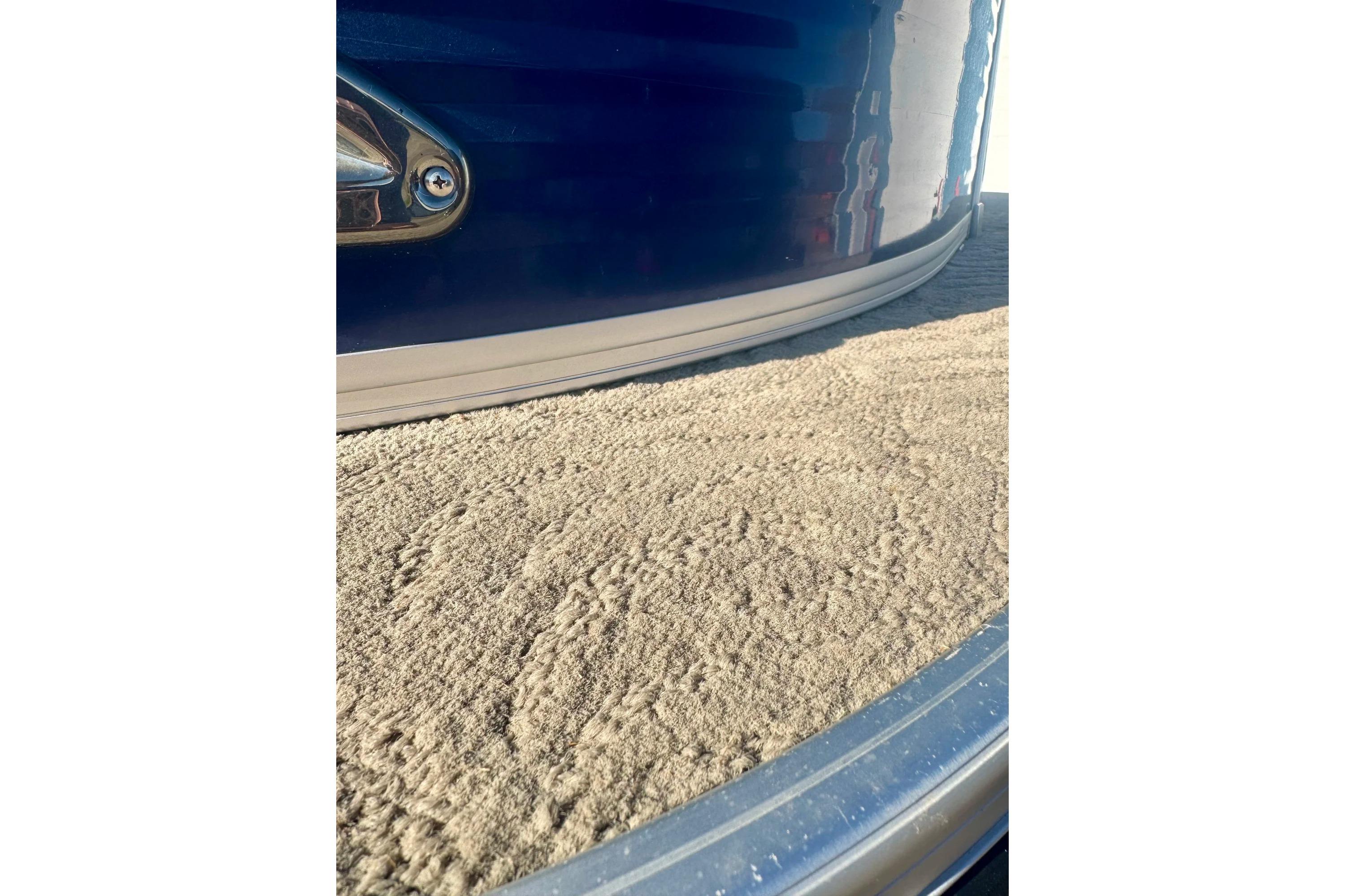 2012 Regency Sun Tracker Party Barge with textured deck and sleek blue exterior.