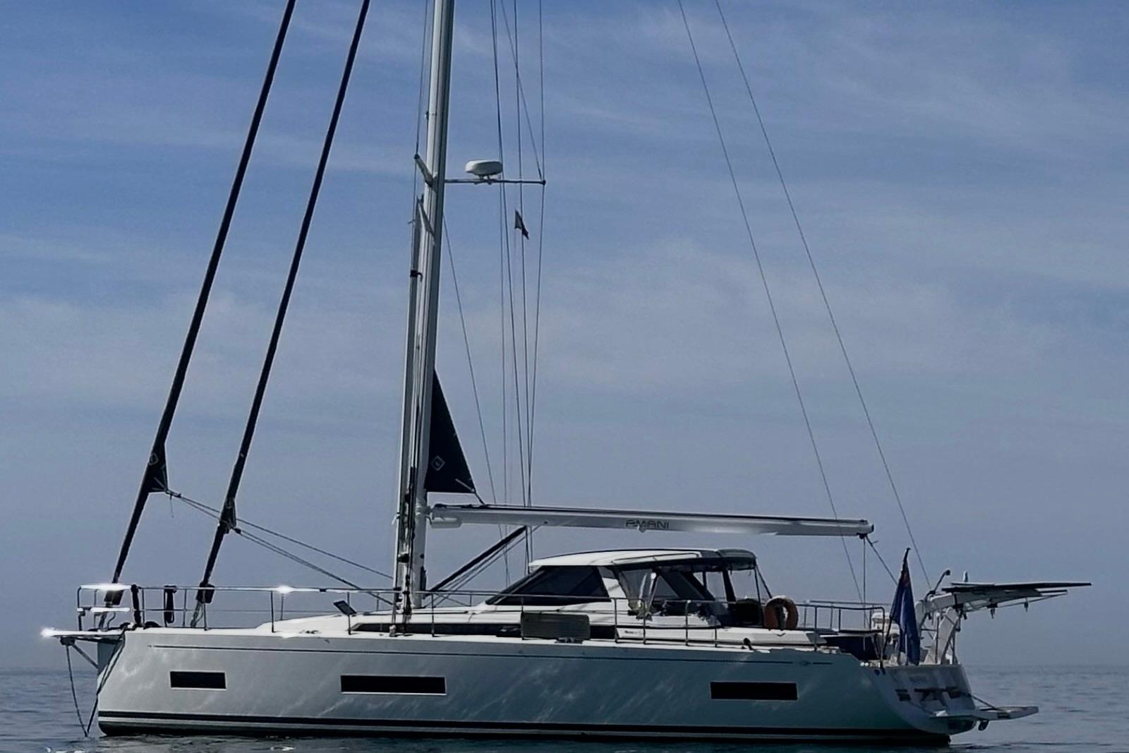 2024 Amel 50 sailboat on calm sea under clear sky.