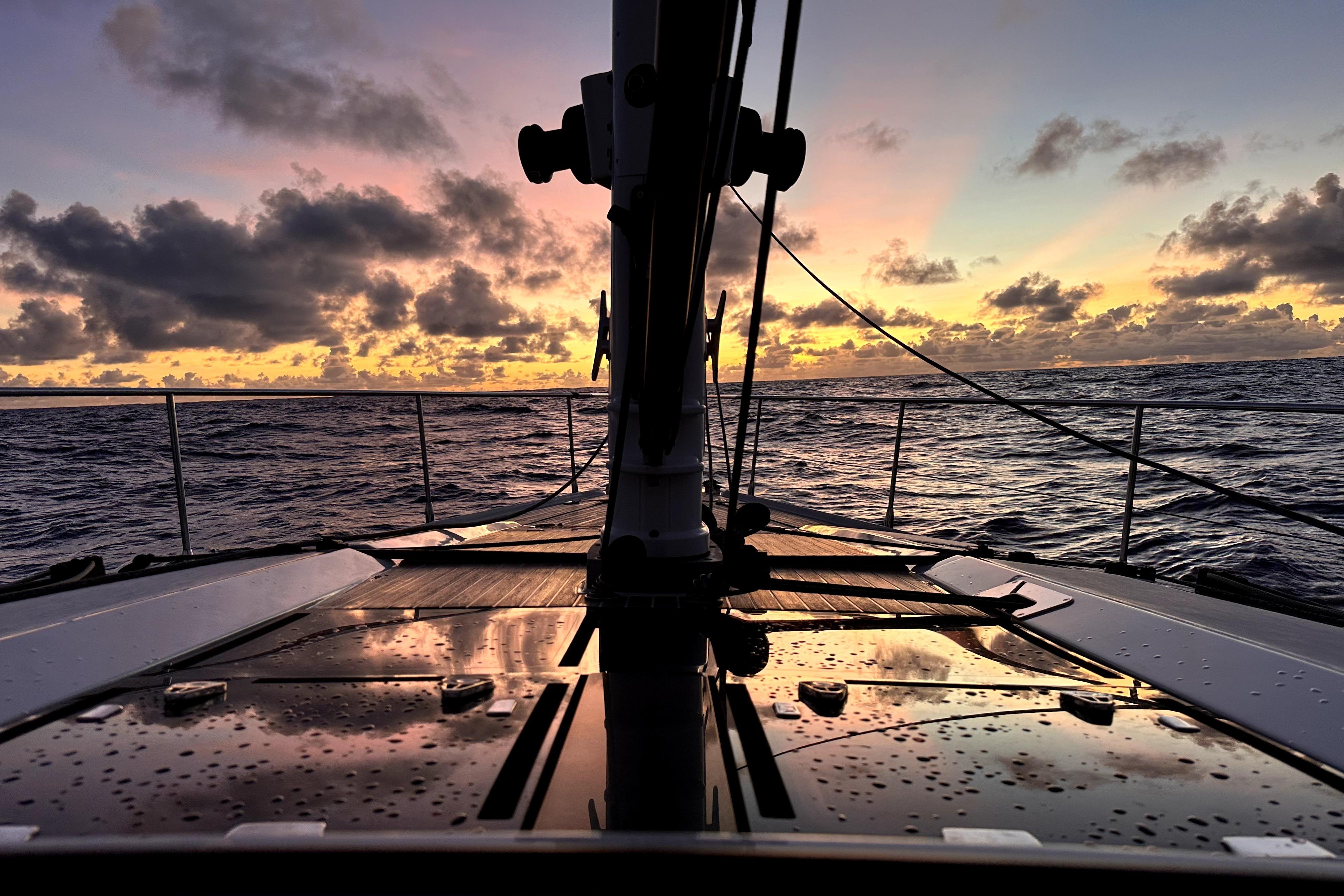 Sailing at sunset on a 2024 Amel 50 yacht, ocean view.