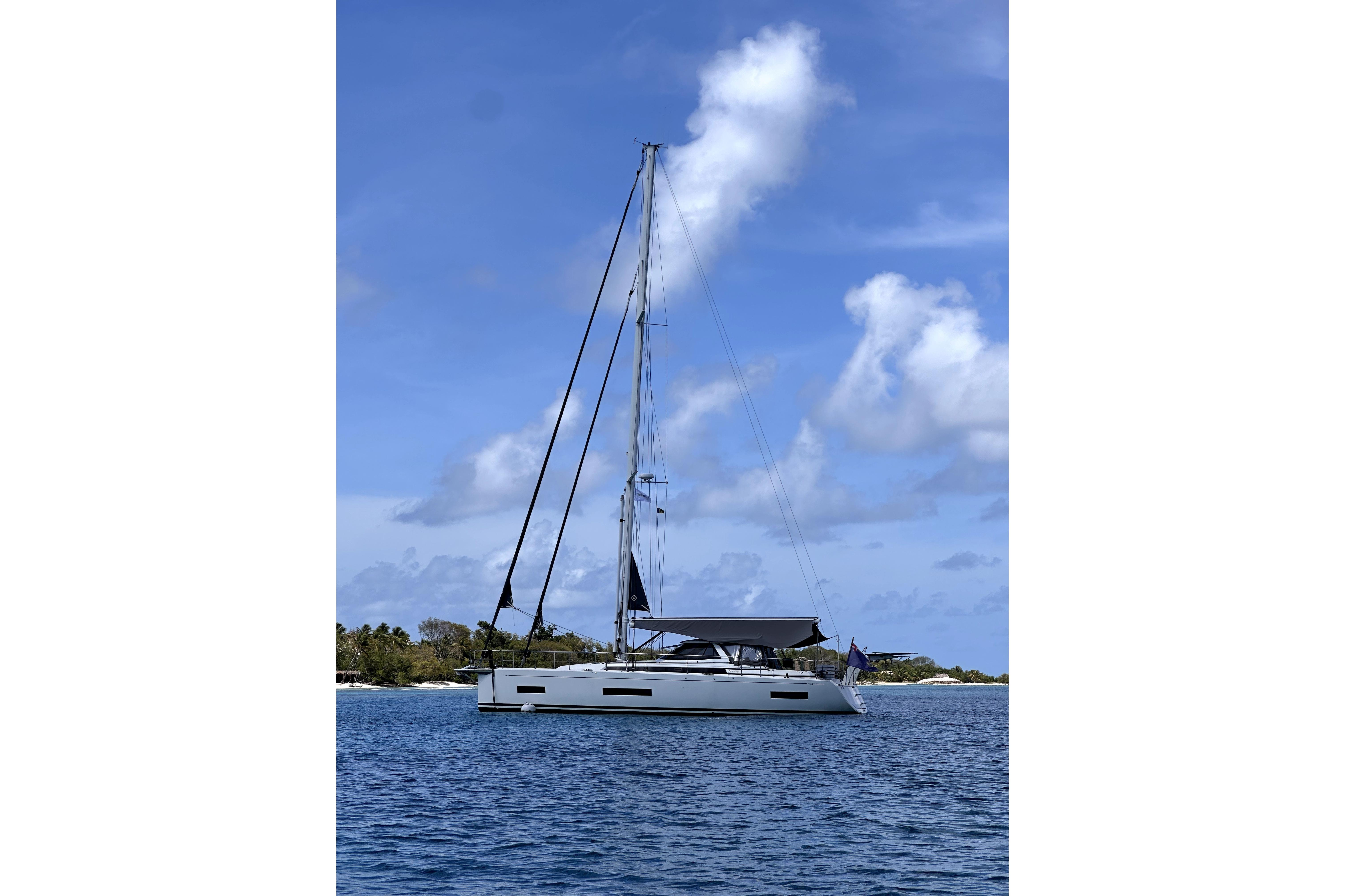 2024 Amel 50 sailboat on calm blue waters under a clear sky.