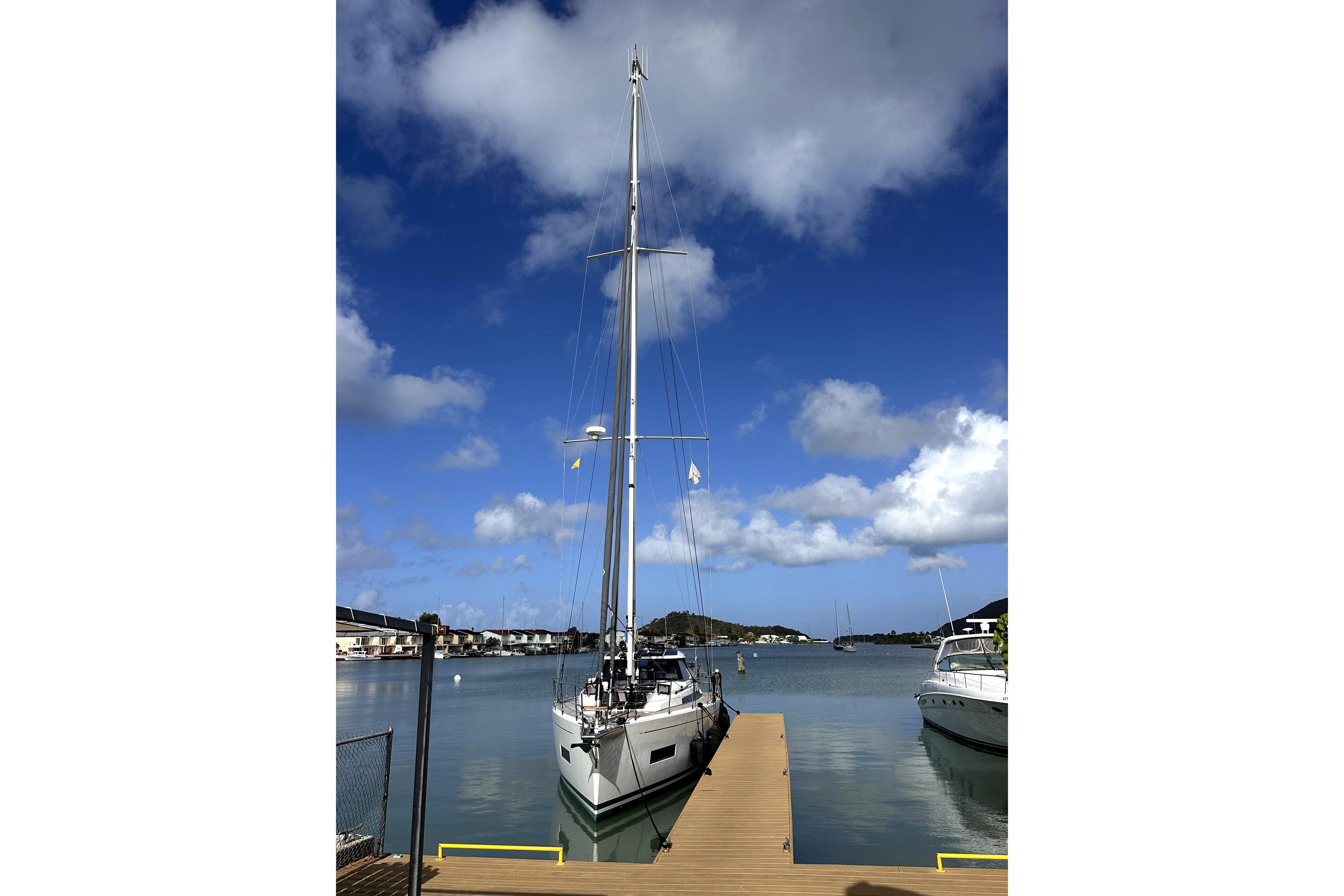 Sailboat Amel 50, 2024 model, docked under a vibrant blue sky.