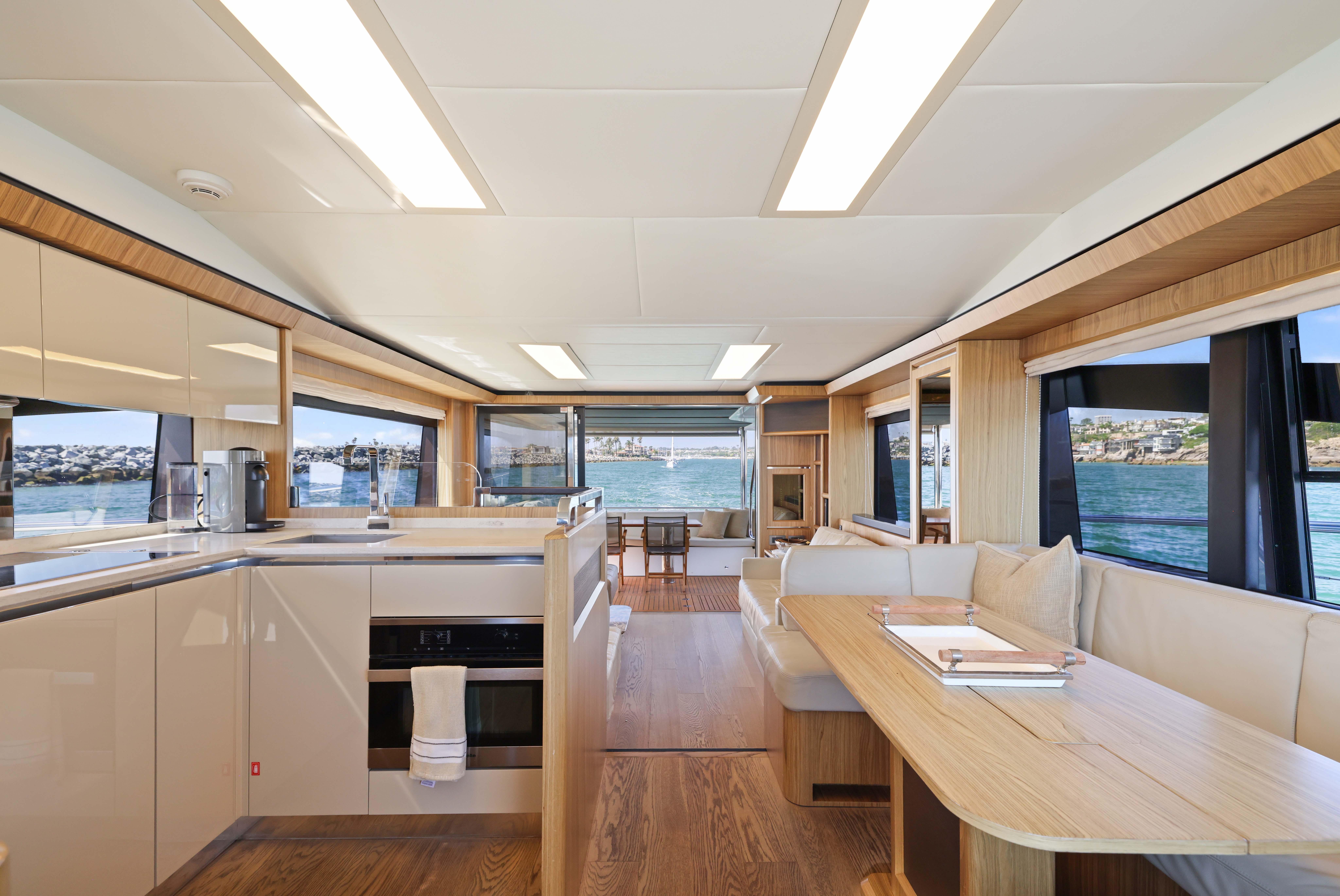 Luxurious interior of 2015 Absolute Fly Co Ownership yacht with modern kitchen and dining area.