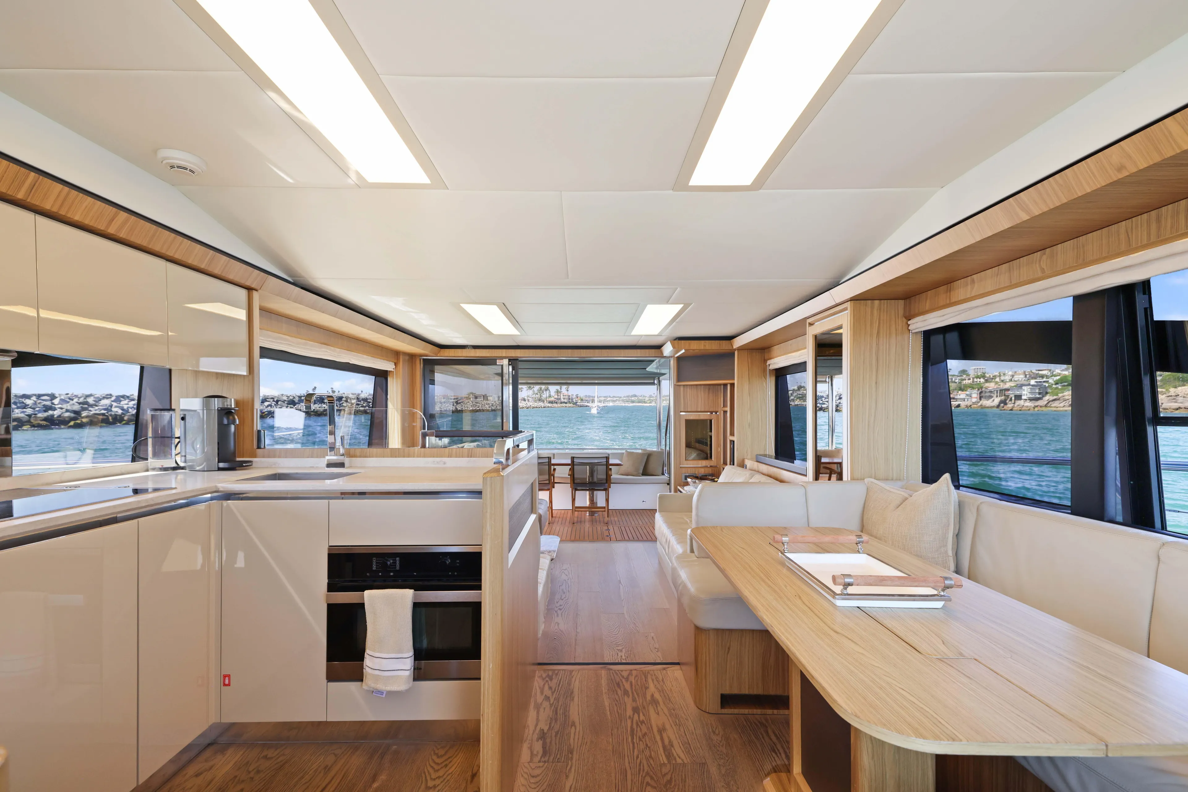 Luxurious interior of 2015 Absolute Fly Co Ownership yacht with modern kitchen and dining area.