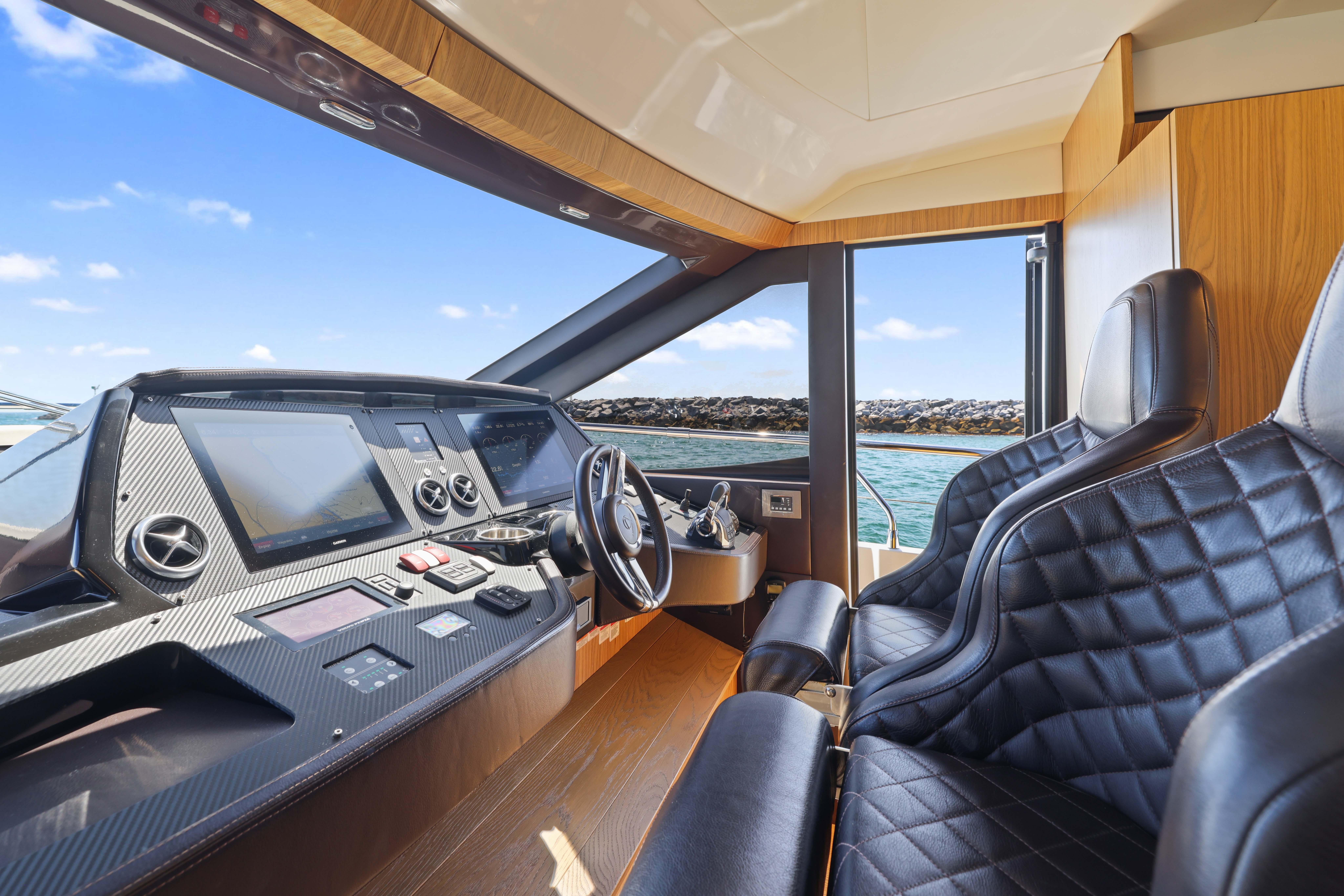 Luxurious yacht cockpit with leather seats and modern controls, Absolute Fly Co Ownership 2015 model.