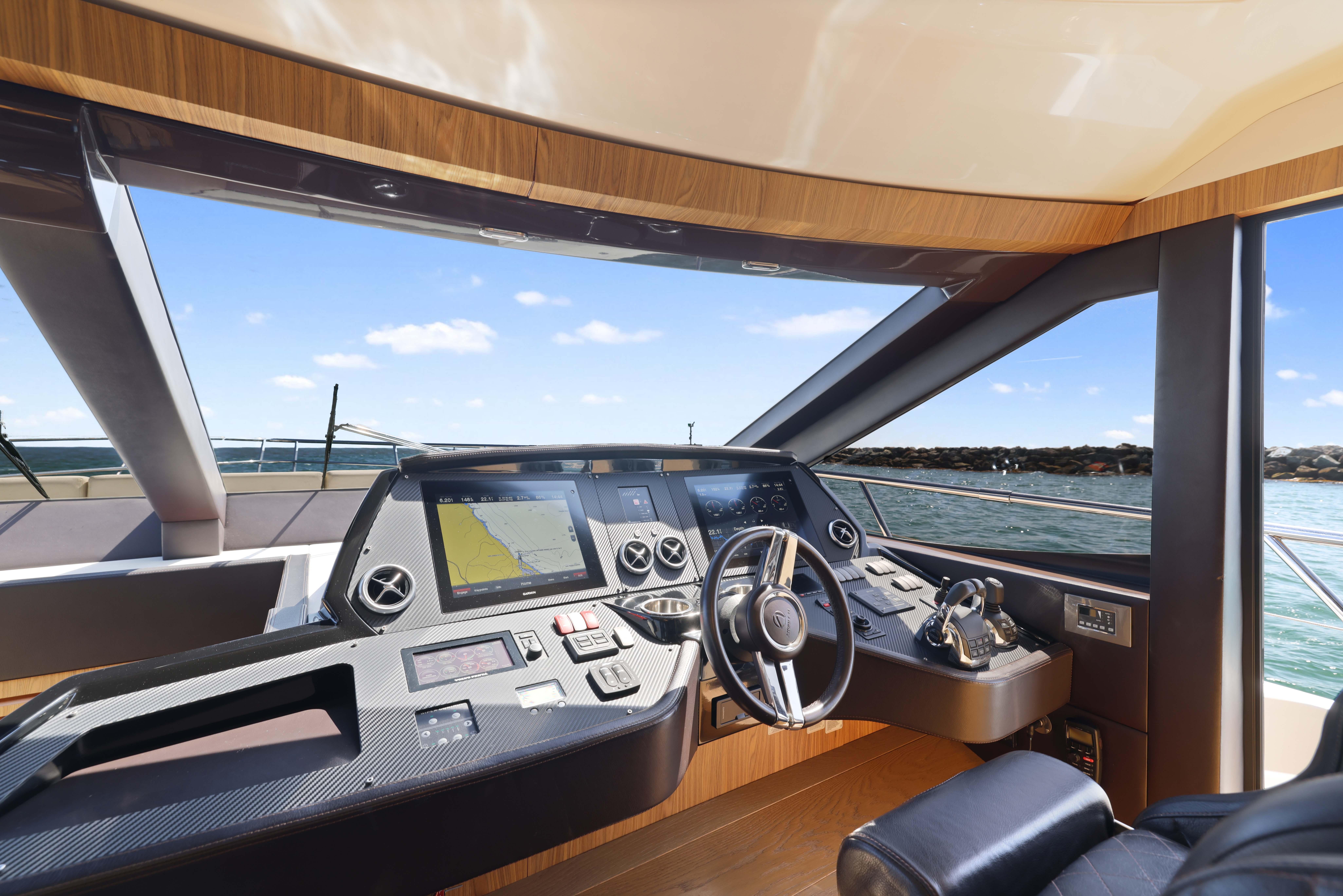 Luxurious 2015 Absolute Fly Co Ownership yacht cockpit with modern navigation equipment.
