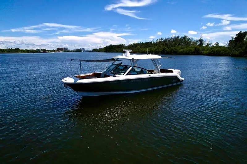Getting There Yacht Photos Pics 2017 Boston Whaler Vantage 320 boat on calm water under blue sky.