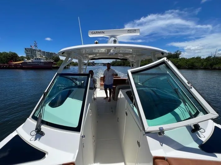 Getting There Yacht Photos Pics 2017 Boston Whaler Vantage 320 boat on a sunny day, featuring open deck and Garmin radar.