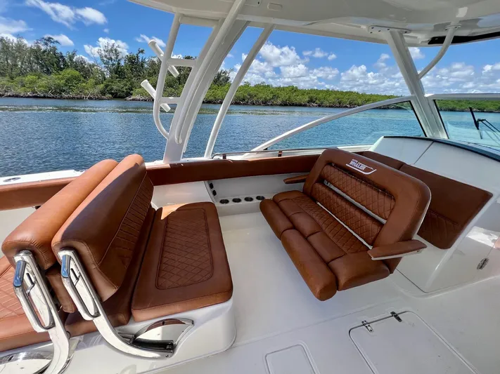 Getting There Yacht Photos Pics 2017 Boston Whaler Vantage 320 interior with brown leather seating, scenic water view.