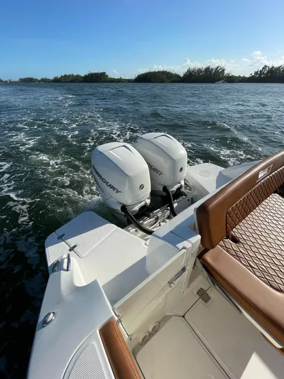 Getting There Yacht Photos Pics 2017 Boston Whaler Vantage 320 boat with twin engines on open water.