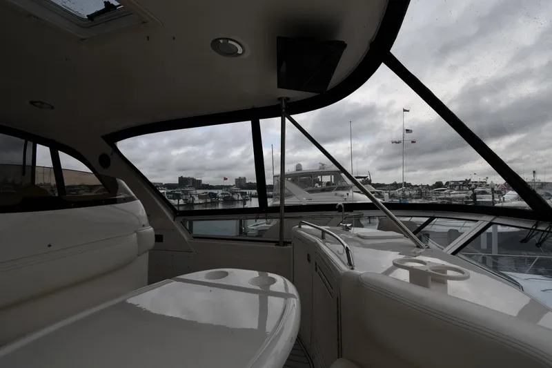 007 Yacht Photos Pics Interior view of 2001 Sea Ray 480 Sedan Bridge yacht with marina backdrop.