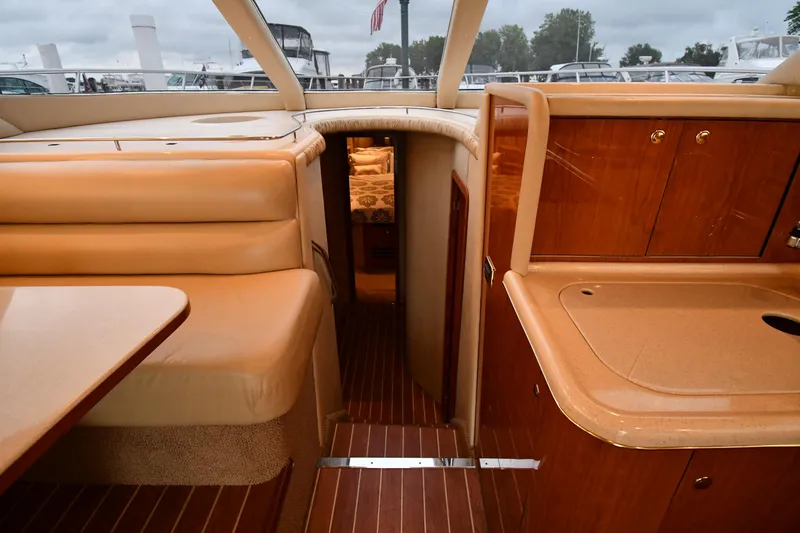 007 Yacht Photos Pics Interior of 2001 Sea Ray 480 Sedan Bridge yacht with wood finishes and seating area.
