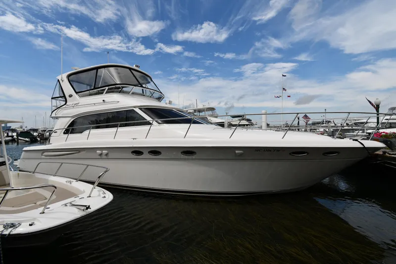 007 Yacht Photos Pics 2001 Sea Ray 480 Sedan Bridge yacht docked under a vibrant blue sky.