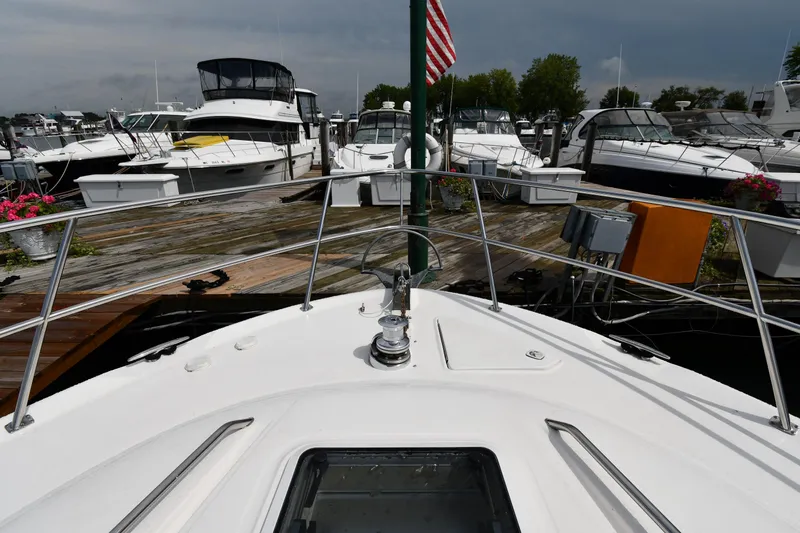 007 Yacht Photos Pics 2001 Sea Ray 480 Sedan Bridge yacht docked at marina with other boats.