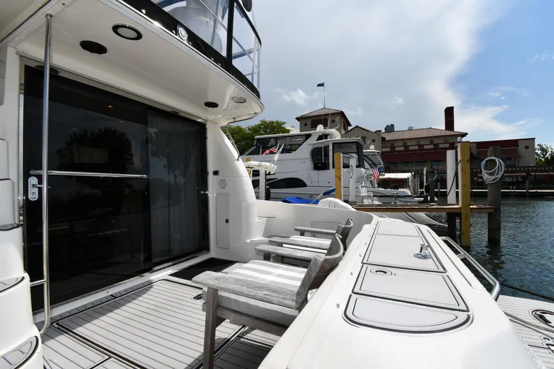 007 Yacht Photos Pics 2001 Sea Ray 480 Sedan Bridge yacht docked, featuring spacious deck and seating area.
