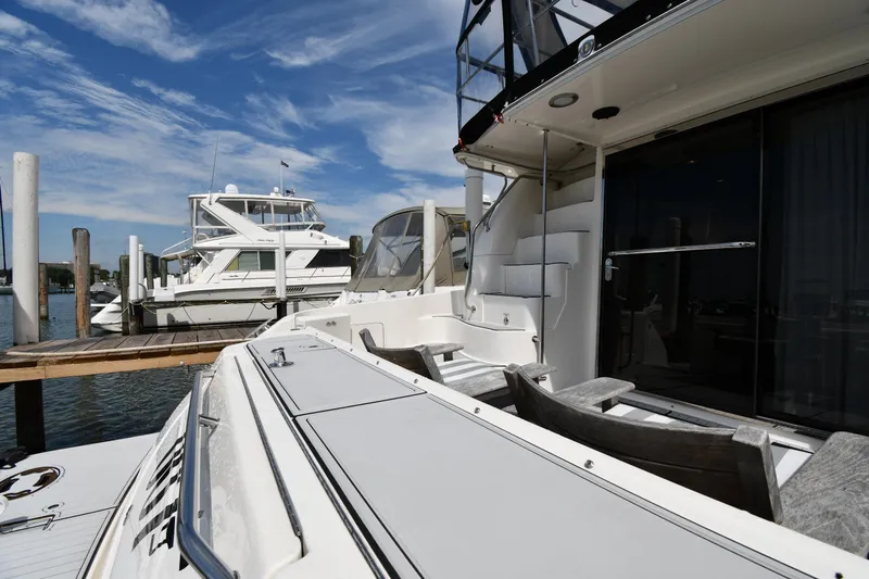 007 Yacht Photos Pics 2001 Sea Ray 480 Sedan Bridge yacht docked at marina under blue sky.