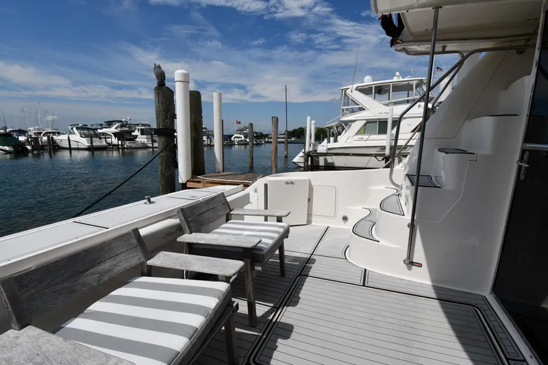007 Yacht Photos Pics 2001 Sea Ray 480 Sedan Bridge yacht docked at marina, featuring spacious deck seating.