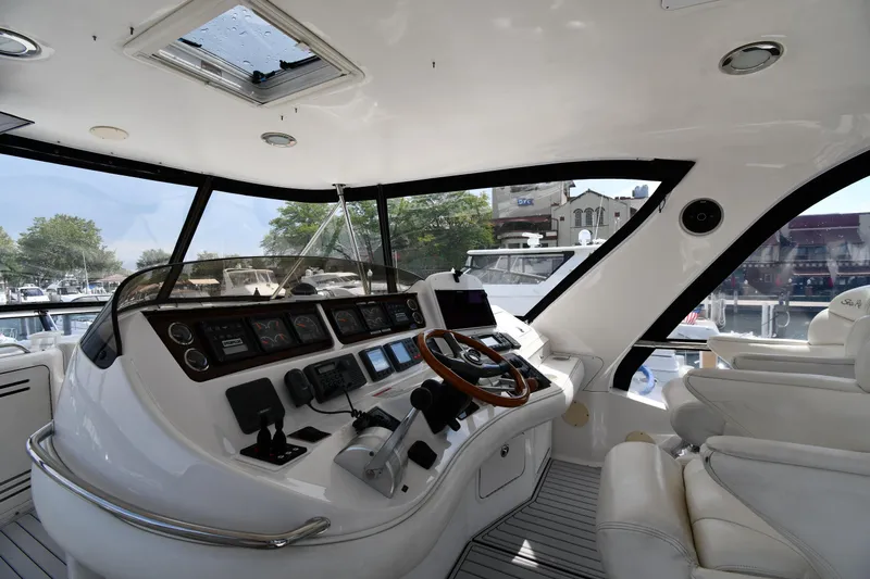 007 Yacht Photos Pics Interior view of 2001 Sea Ray 480 Sedan Bridge yacht cockpit with modern controls and seating.