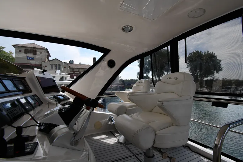 007 Yacht Photos Pics Interior view of 2001 Sea Ray 480 Sedan Bridge yacht with luxurious seating and control panel.