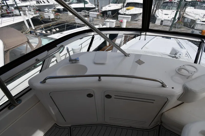 007 Yacht Photos Pics 2001 Sea Ray 480 Sedan Bridge yacht interior with sink and seating, docked at marina.
