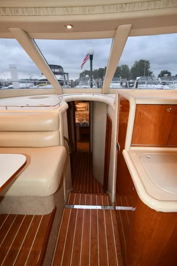 007 Yacht Photos Pics Interior view of 2001 Sea Ray 480 Sedan Bridge yacht with wood flooring and seating.