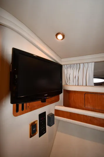 007 Yacht Photos Pics Interior of 2001 Sea Ray 480 Sedan Bridge with mounted TV and wood accents.