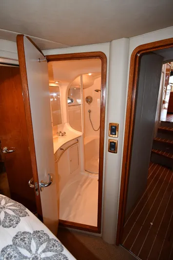 007 Yacht Photos Pics 2001 Sea Ray 480 Sedan Bridge yacht bathroom with shower and wooden accents.
