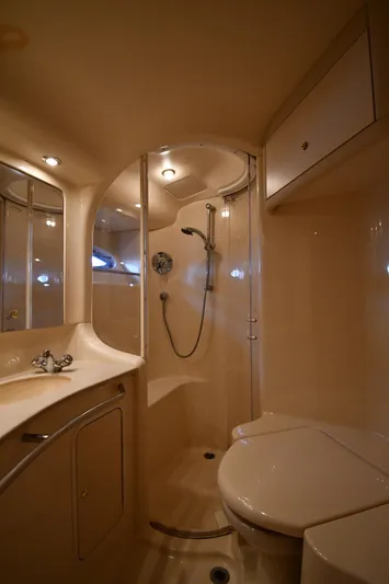 007 Yacht Photos Pics Luxurious bathroom in 2001 Sea Ray 480 Sedan Bridge yacht, featuring shower and vanity.