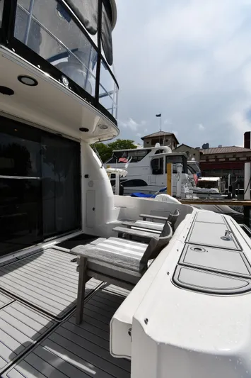 007 Yacht Photos Pics 2001 Sea Ray 480 Sedan Bridge yacht docked at marina, showcasing sleek design and spacious deck.