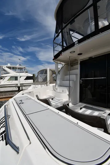 007 Yacht Photos Pics 2001 Sea Ray 480 Sedan Bridge yacht docked under a clear blue sky.