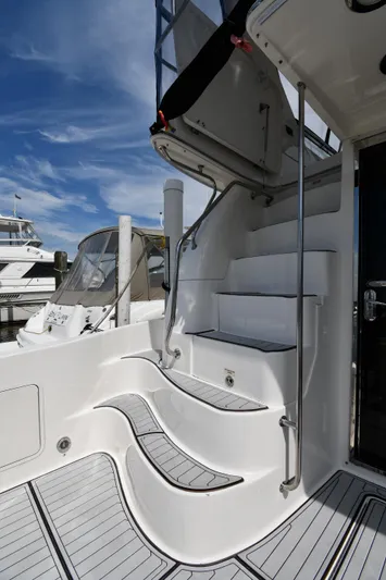 007 Yacht Photos Pics 2001 Sea Ray 480 Sedan Bridge yacht with elegant white stairs and sleek design.