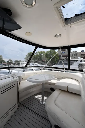 007 Yacht Photos Pics 2001 Sea Ray 480 Sedan Bridge interior with white seating and table.