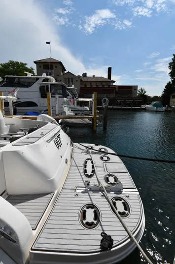 007 Yacht Photos Pics 2001 Sea Ray 480 Sedan Bridge docked at a marina under a partly cloudy sky.