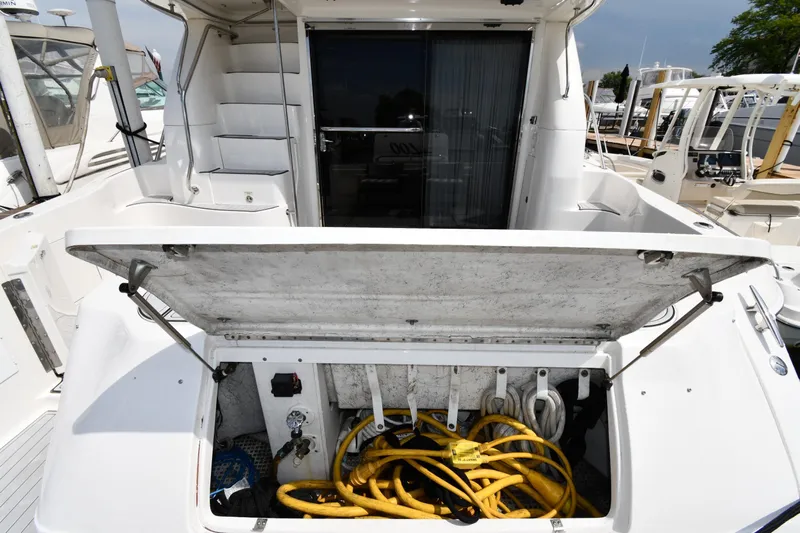 007 Yacht Photos Pics 2001 Sea Ray 480 Sedan Bridge yacht with open storage compartment and coiled cables.