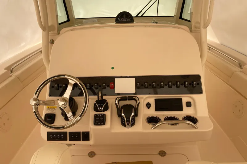  Yacht Photos Pics 2026 Grady-White Canyon 306 helm with steering wheel and control panel.